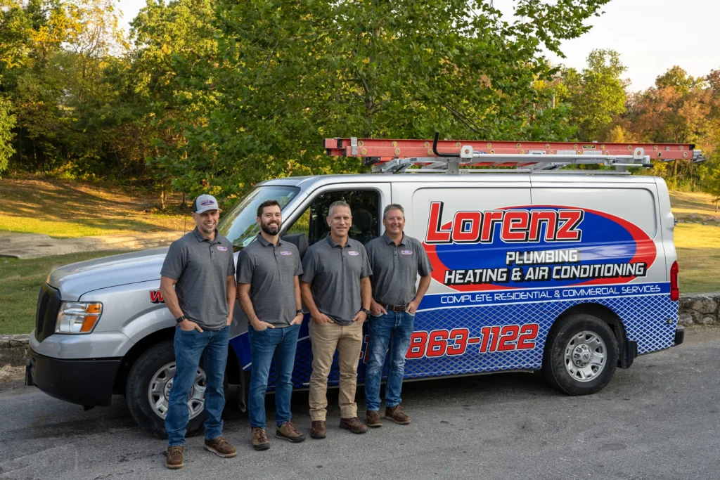 team smiling in front of truck-lorenz plumbing heating and air-springfield