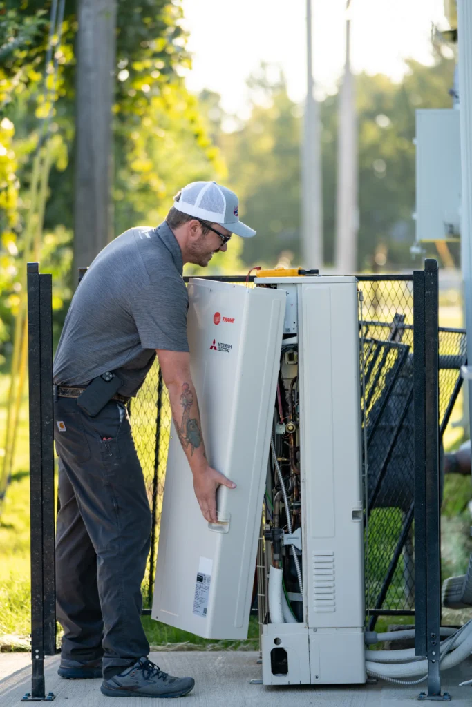 team member installing hvac unit-lorenz plumbing heating and air-springfield