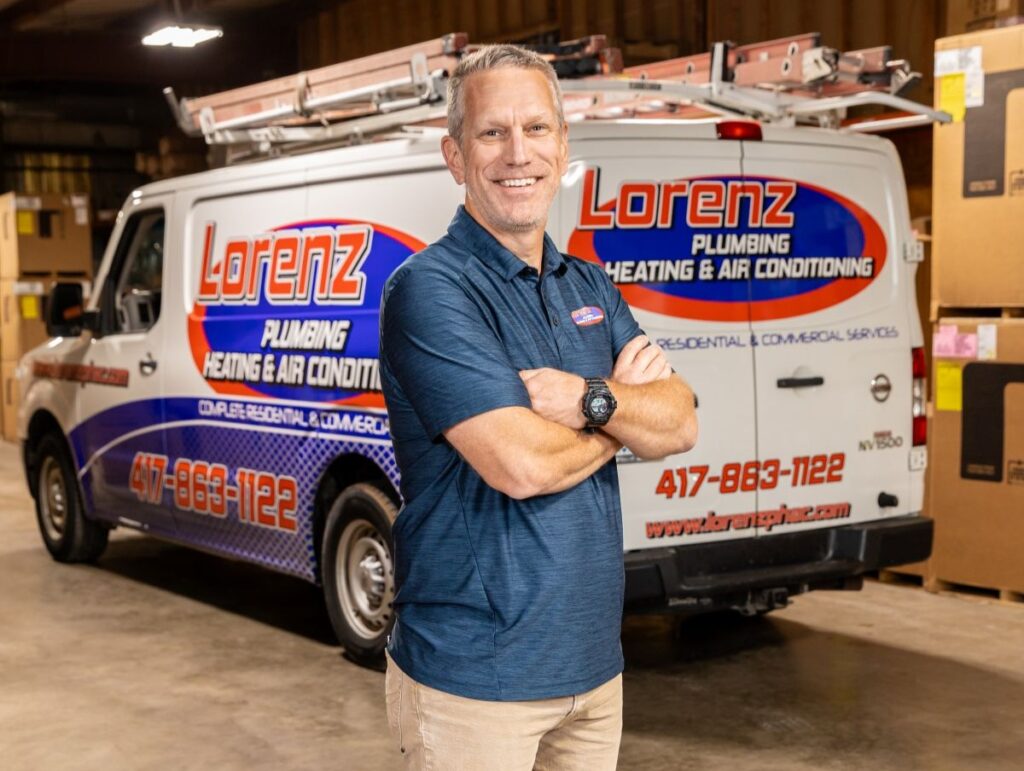 how to unclog a shower drain Lorenz Plumbing worker standing next to branded van