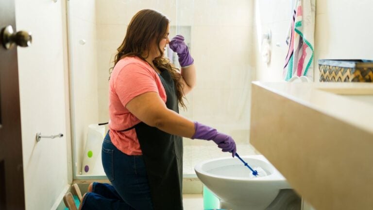 sewer smell in bathroom woman cleaning bad odor