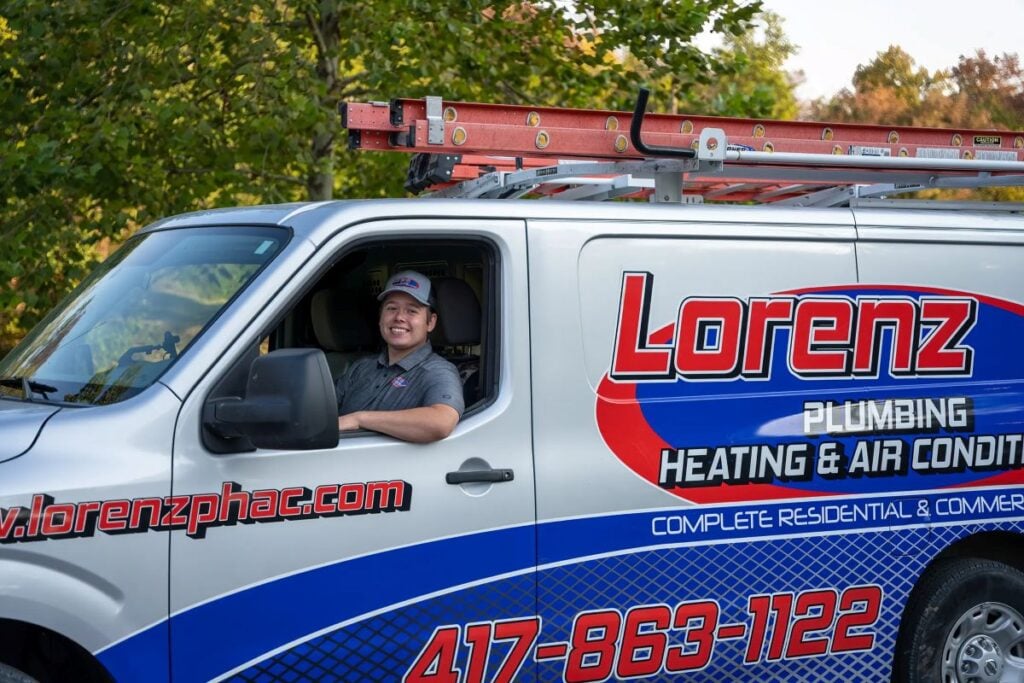 sump pump not working smiling team member in truck-lorenz plumbing heating and air-springfield 