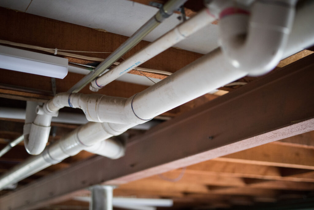 Plumbing water white pipes roof building timber metal structural beam build house