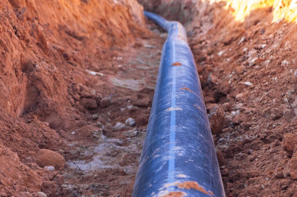 A-black-plastic-pipe-with-a-blue-strip-to-feed-water-to-the-house