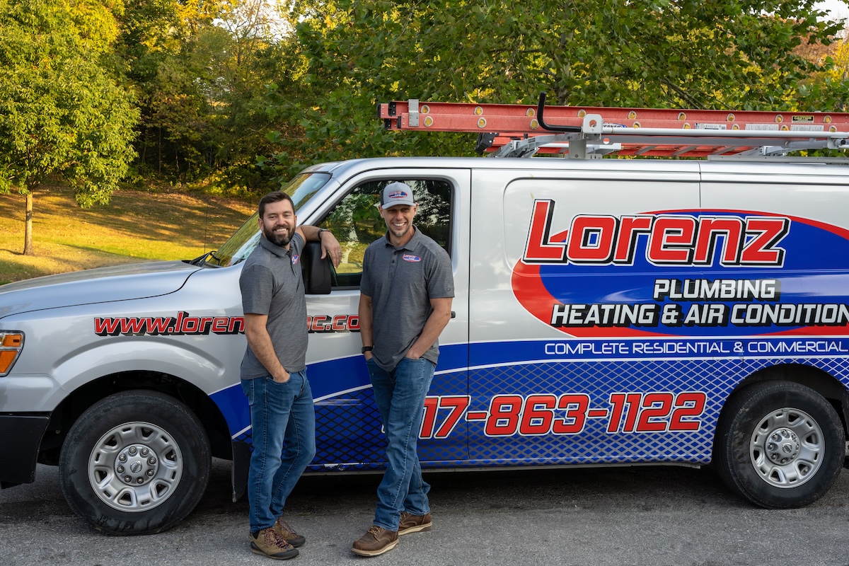 Two-team-members-standing-by-truck