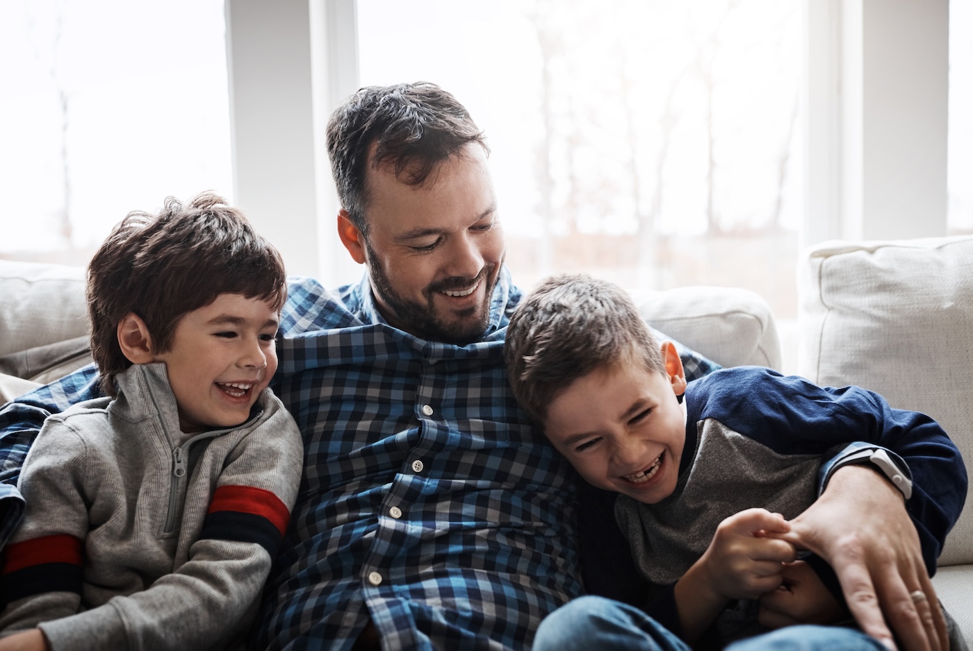 father-hugging-is-sons-in-cozy-home