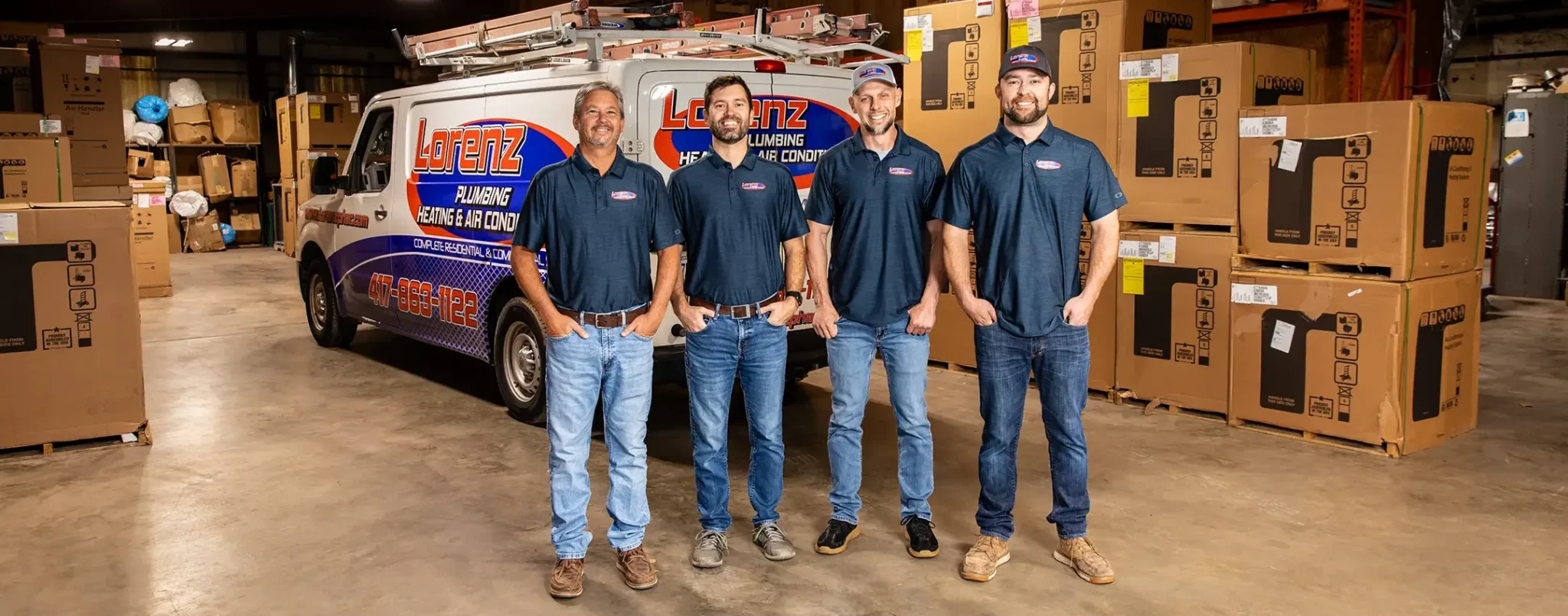 lorenz-team-smiling-in-warehouse-lorenz-plumbing-heating-and-air-springfield