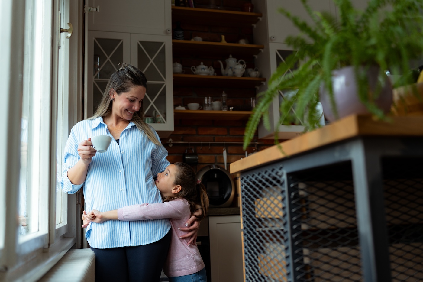 mother-and-daughter-hugging-in-kitchen