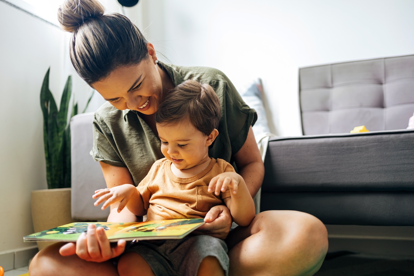 mother-and-son-reading-book-in-home