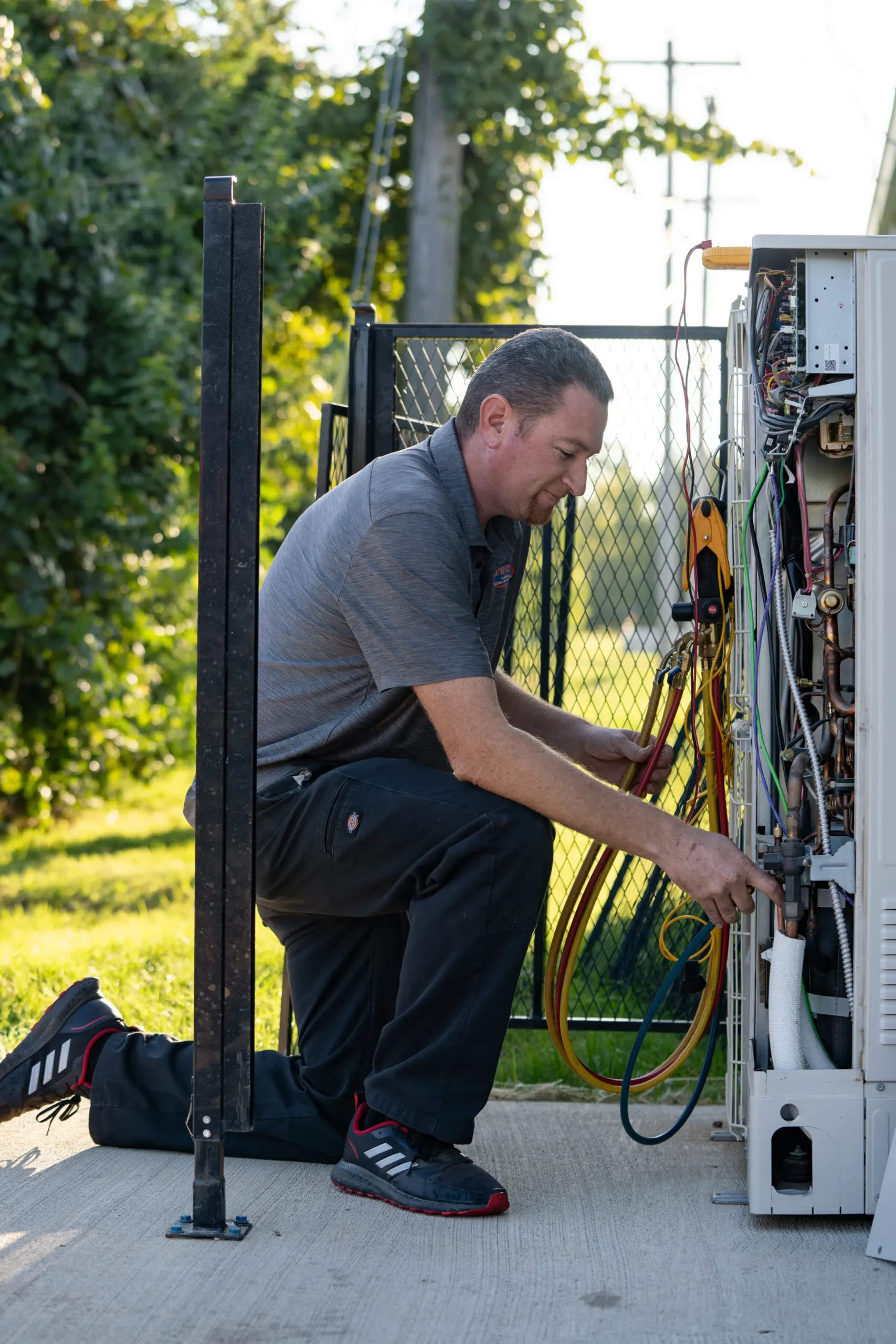 team-member-working-on-hvac-unit-lorenz-plumbing-heating-and-air-springfield