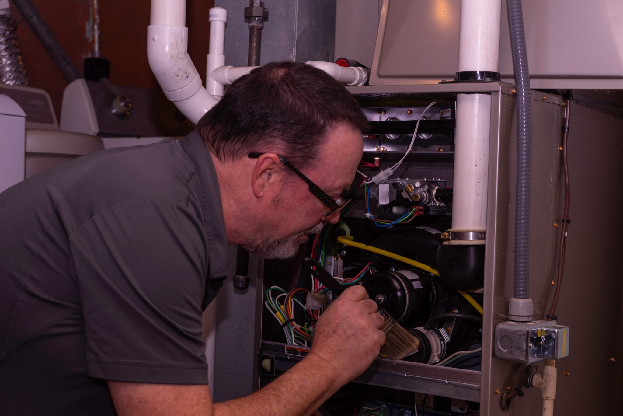 HVAC Tech Cleaning A Furnace Gray Shirt