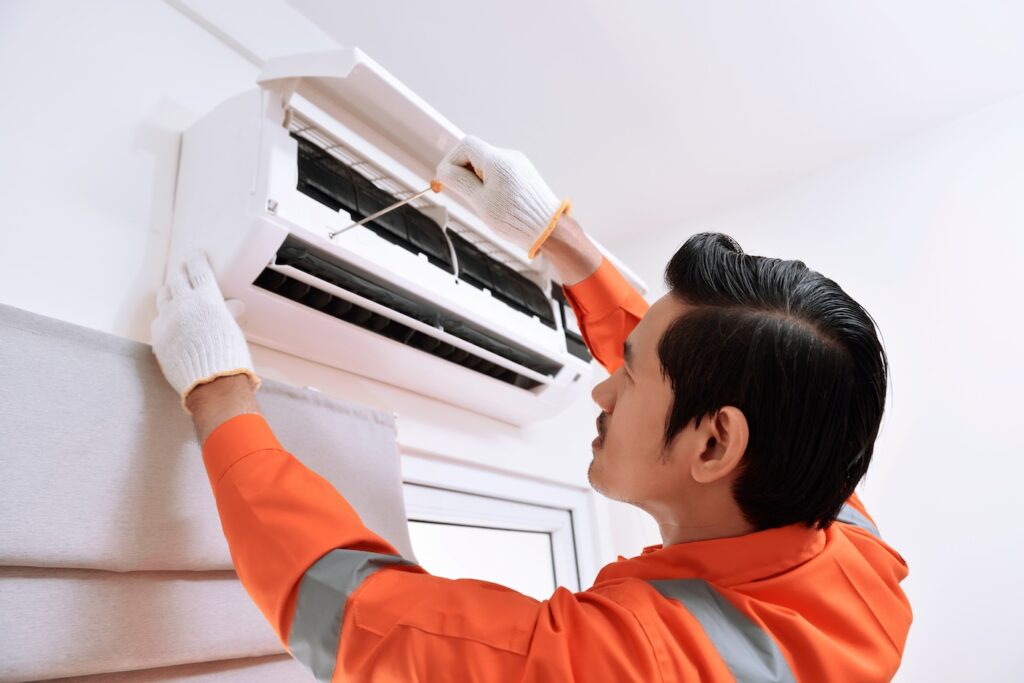 technician-fixing-ductless-ac-unit