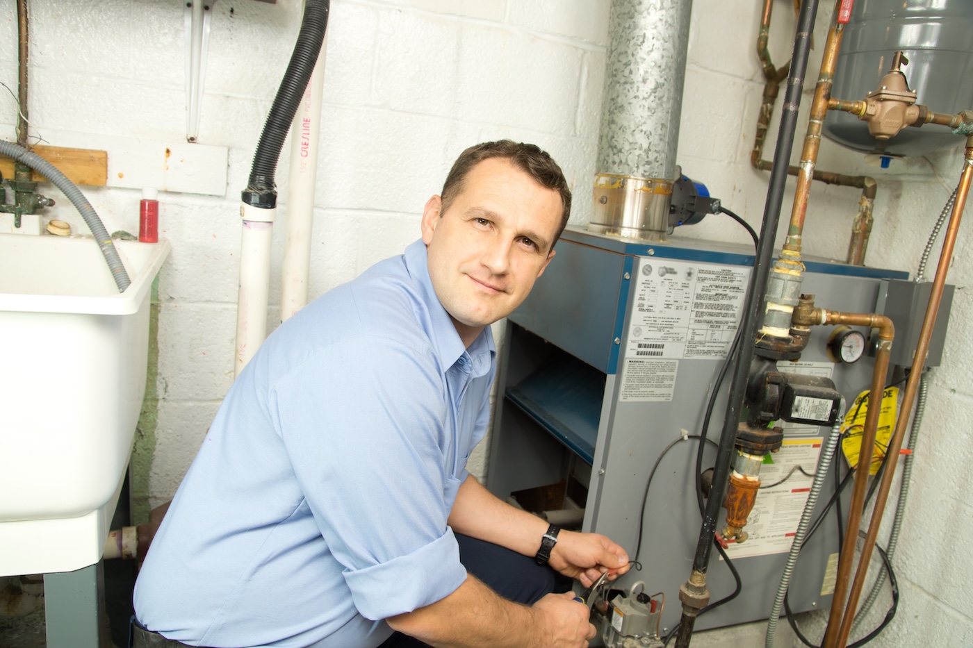technician-installing-new-furance-in-home