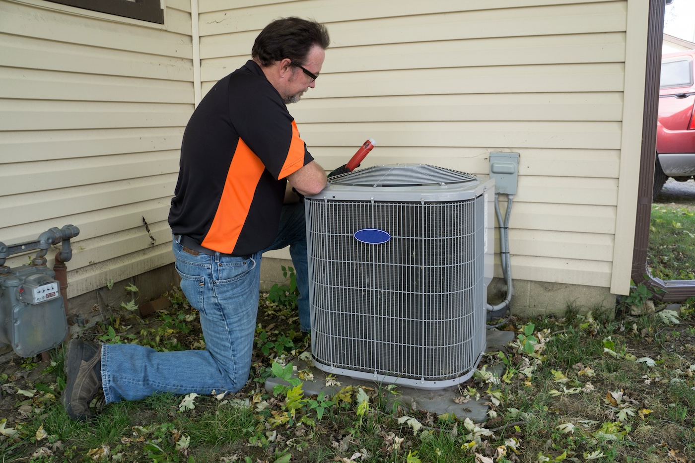 technician-making-repairs-to-air-conditioner