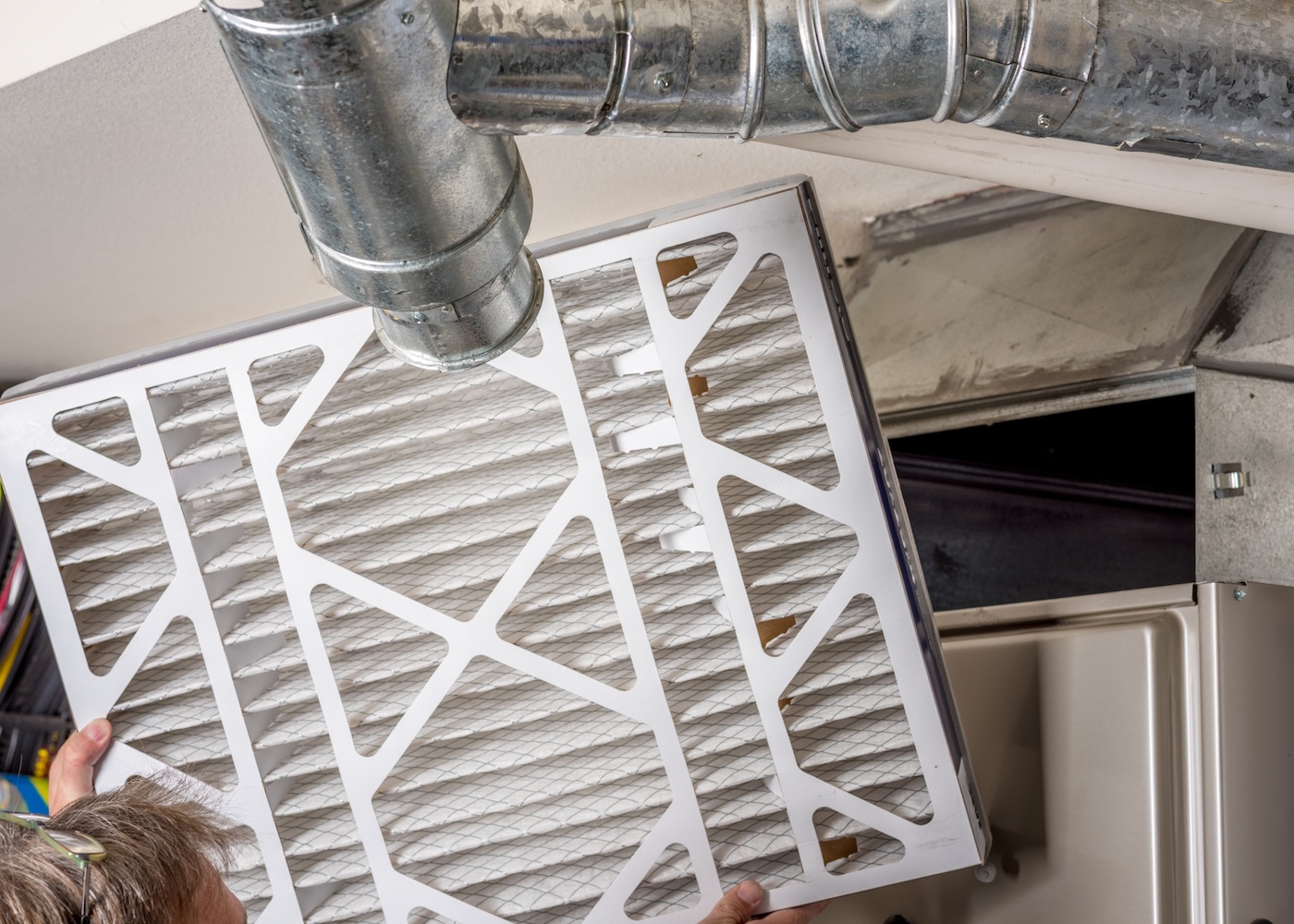 technician-putting-filter-in-new-furnace-replacement
